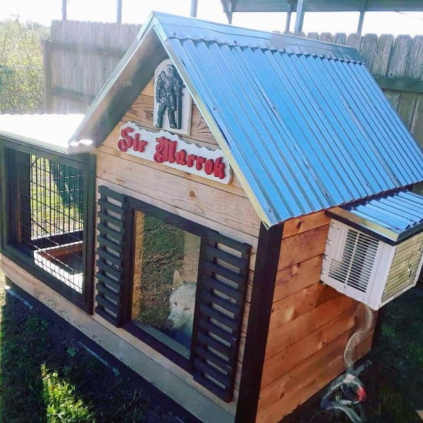 Wooden doghouse with a metal roof, labeled "Sir Marrok," featuring a small air conditioner on the side