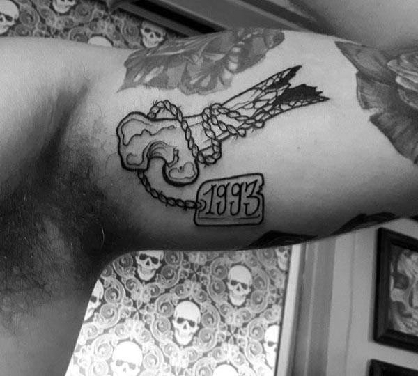 Dog Tag Wrapped Around Bone Mens Bicep Tattoo