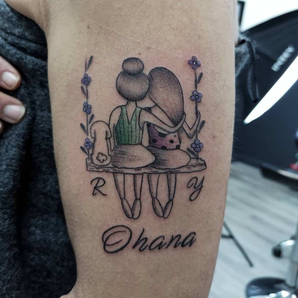 Heartfelt 'Ohana' tattoo of two people sitting on a swing, symbolizing love, family, and deep connection.