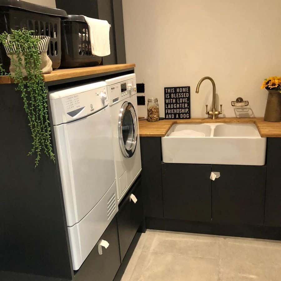 gray cabinet laundry with white apron sink washer and dryer