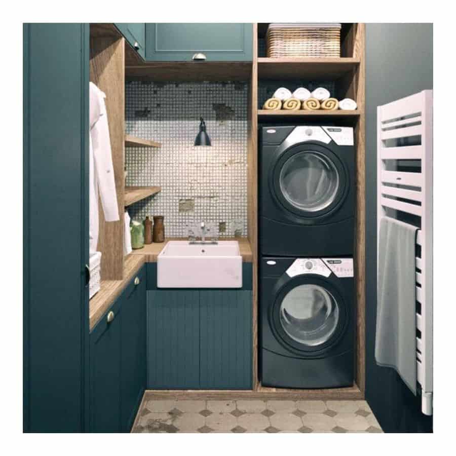 small corner laundry green cabinets apron sink stacked washer and dryer