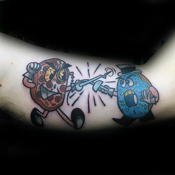 Tattoo of two animated donuts dueling with swords—one red with angry eyes, the other blue with a monocle and top hat.