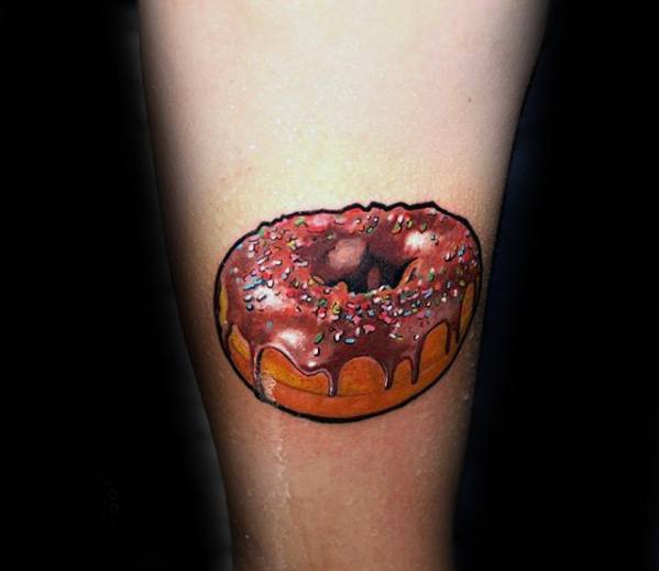Tattoo of a realistic chocolate glazed donut with colorful sprinkles and rich shading for a bold, mouthwatering look.