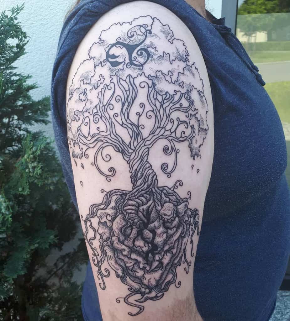 The tattoo features Yggdrasil with intricate swirling branches, floating rocky roots, and a mythical creature, symbolizing Norse mythology and cosmic balance.