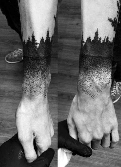 Forearm tattoo of a forest transitioning into dots on a person's arm