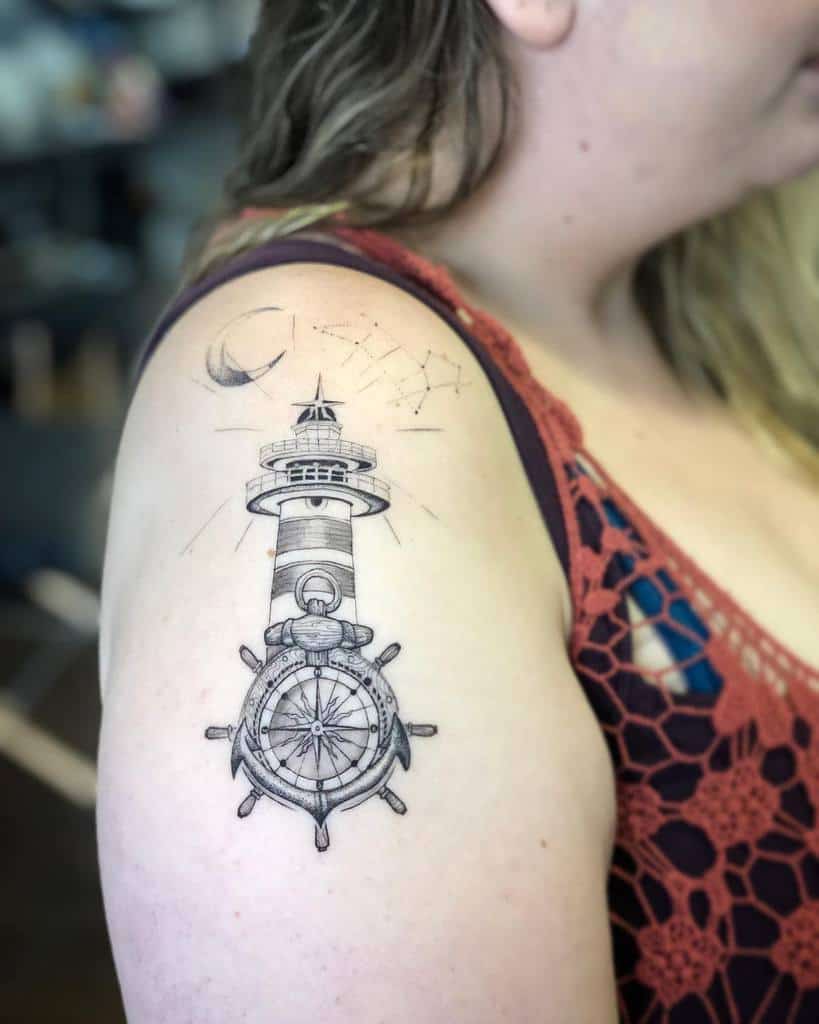 Blackwork tattoo of a lighthouse and ship’s wheel, blending maritime and celestial elements for a symbolic look.