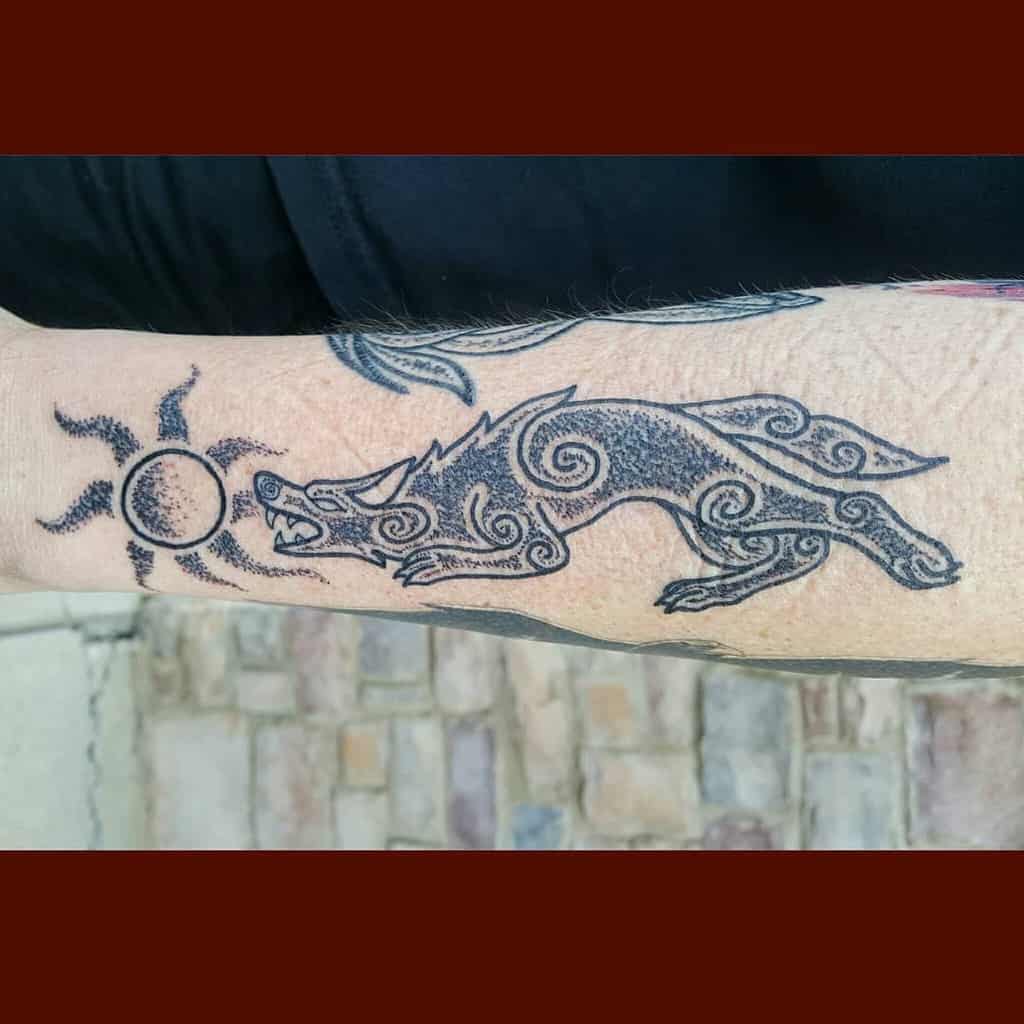 This design features a Norse wolf in intricate dotwork style, chasing the sun, symbolizing power and eternal pursuit