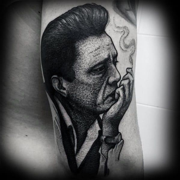 Black and white tattoo of Johnny Cash, a contemplative man with smoke curling upward