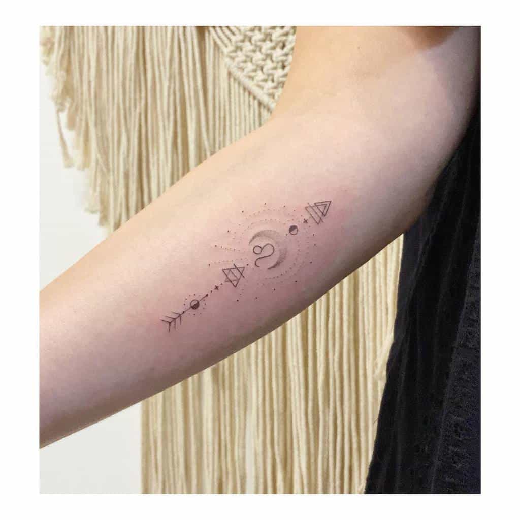 Minimalist Leo tattoo featuring a cosmic-inspired sun, dotted details, and symbolic geometric shapes.