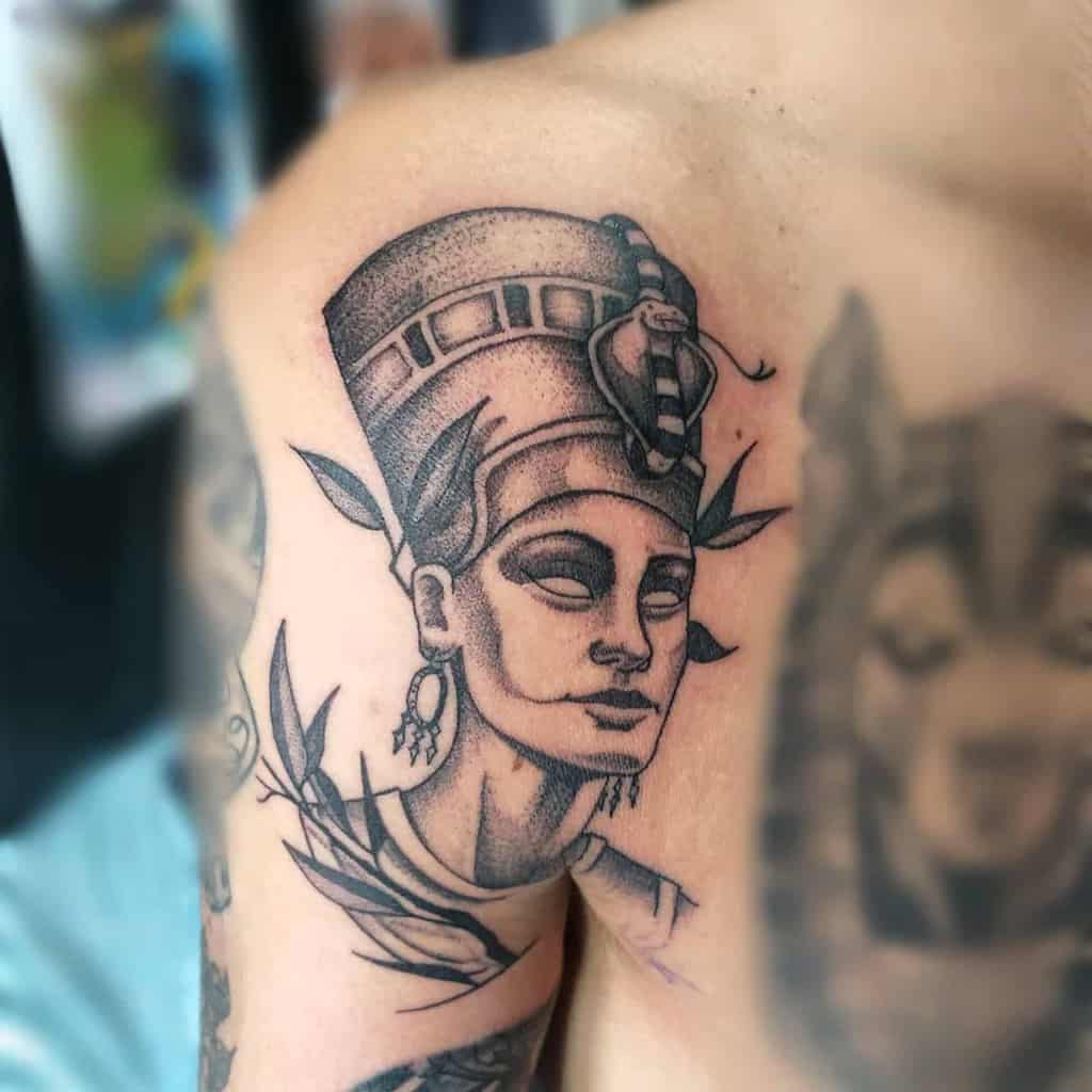 Dotwork tattoo of Nefertiti wearing a headdress, elegantly inked on a shoulder