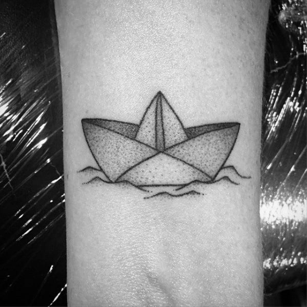 Simple paper boat tattoo with dotwork shading, floating on gentle waves, symbolizing adventure, resilience, and nostalgia.