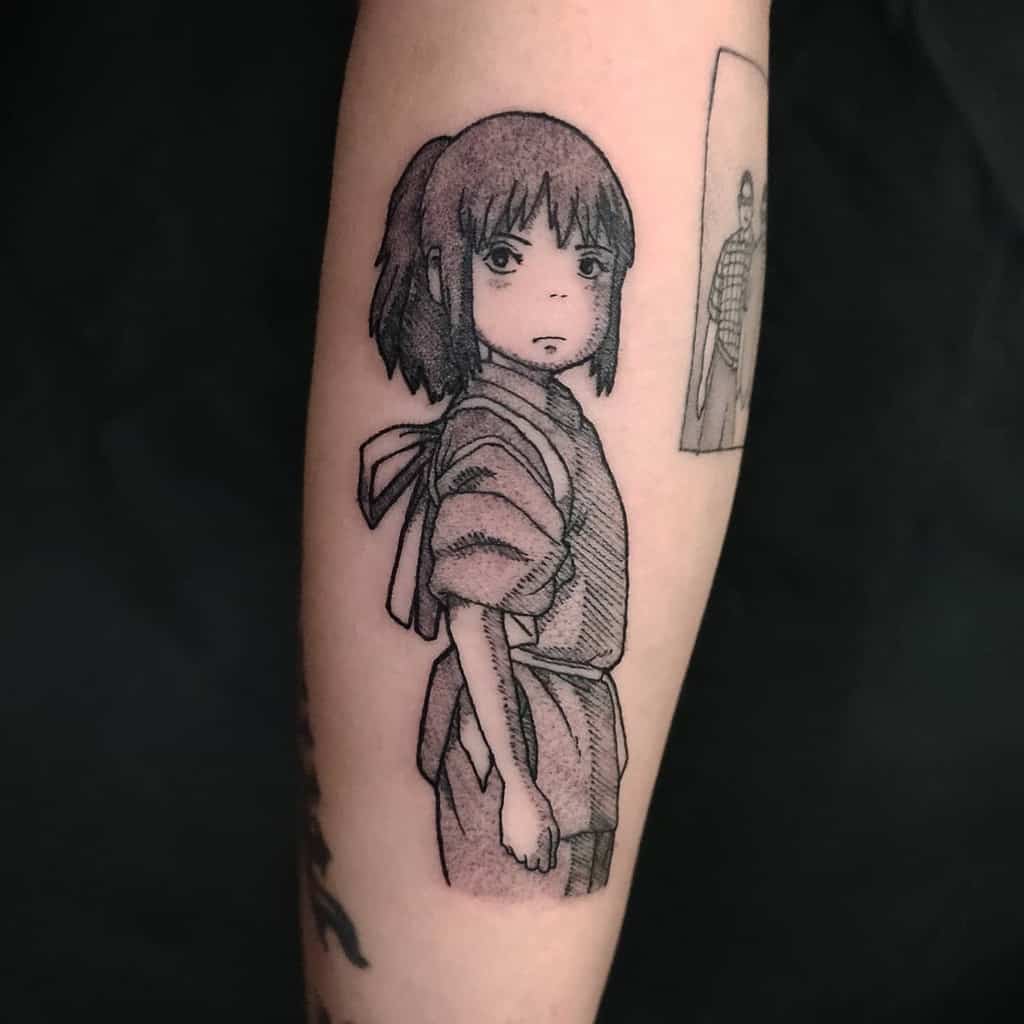 Black and grey tattoo of Chihiro from Spirited Away, featuring fine linework, capturing her determined expression