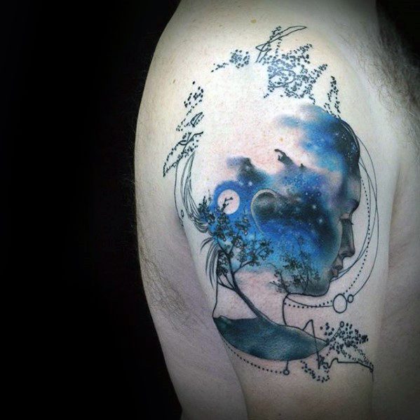 Ethereal tattoo of a serene face filled with a starry night sky, trees, and birds, framed by delicate line art and celestial details.