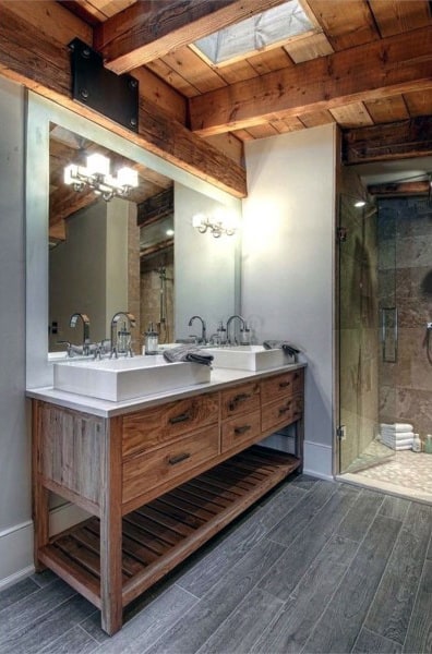 Rustic bathroom with wooden beams, double sink vanity, large mirror, and glass shower