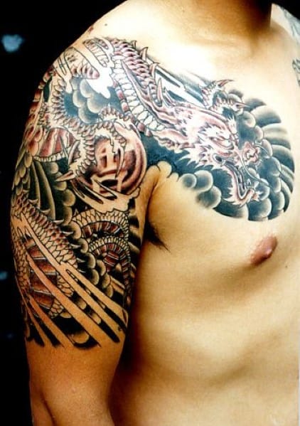 Tattooed arm and chest featuring a detailed dragon design
