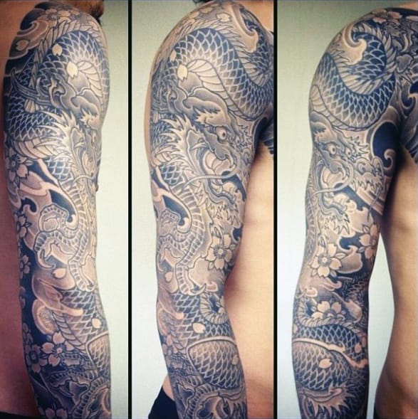 Sleeve tattoo with intricate dragon and floral designs