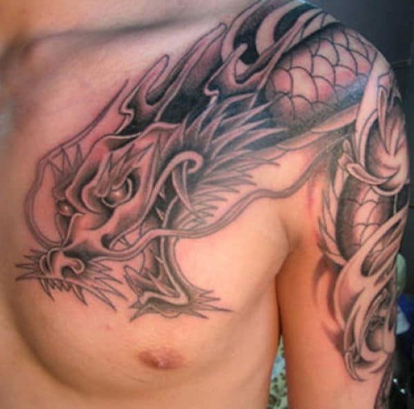 A detailed dragon tattoo on a man's chest and shoulder