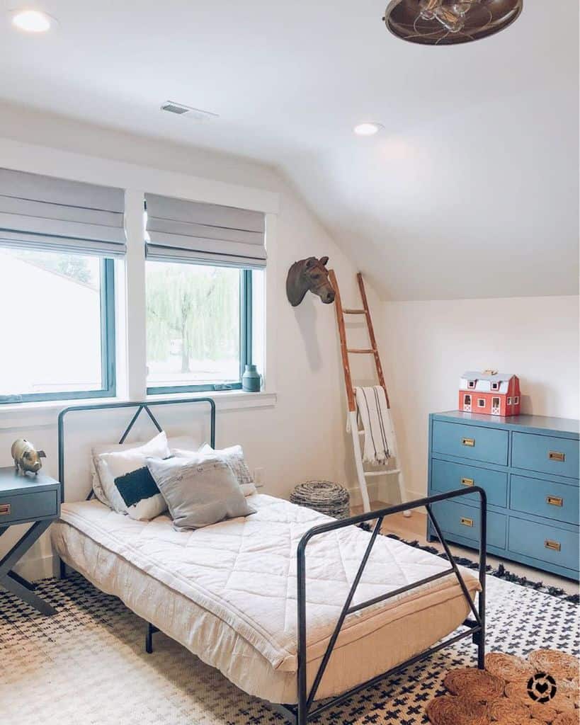 Kids' room with a single bed, blue dresser, horse head wall art, and rustic ladder decor.