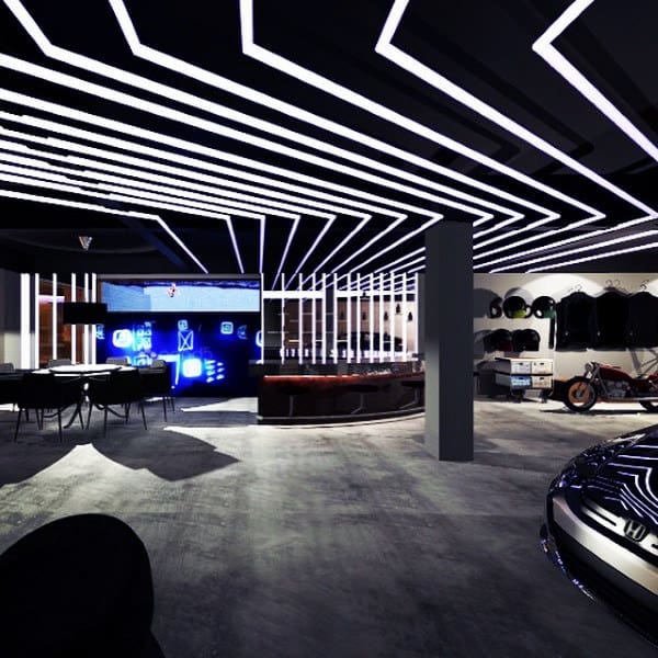 A modern garage with futuristic lighting, a lounge area, and a sleek bar setup.