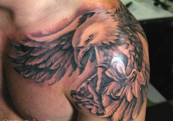 Tattoo of a detailed eagle with wings spread, covering a person's shoulder
