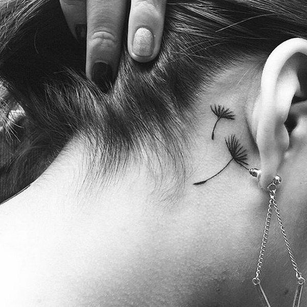 Delicate dandelion seed tattoo behind the ear, symbolizing freedom, dreams, and letting go.