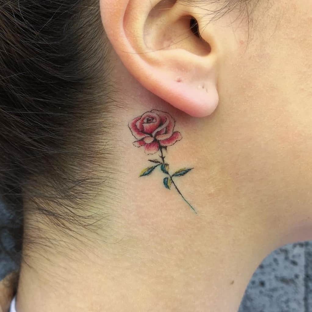 A small rose tattoo behind an ear