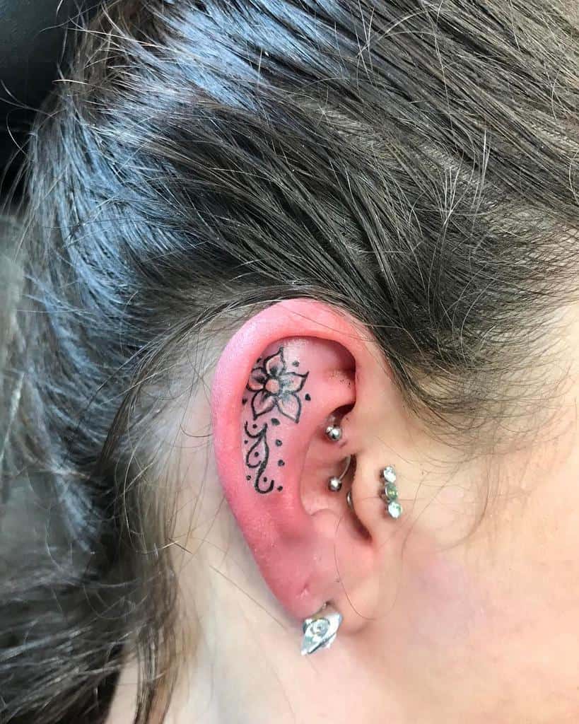 A small floral tattoo on an ear