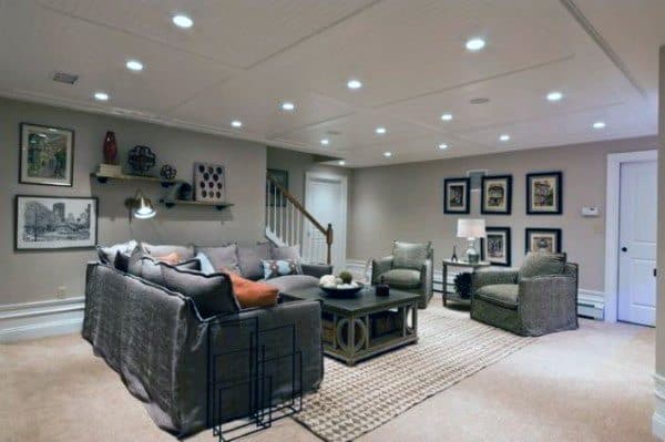 Cozy basement with a white molded ceiling, sectional sofa, and gallery wall decor.