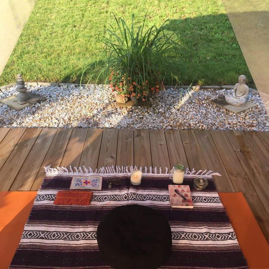 wood deck backyard small gravel garden with statue 