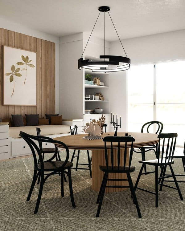 Eclectic boho dining room with minimalist design, wooden chairs, and modern lighting.