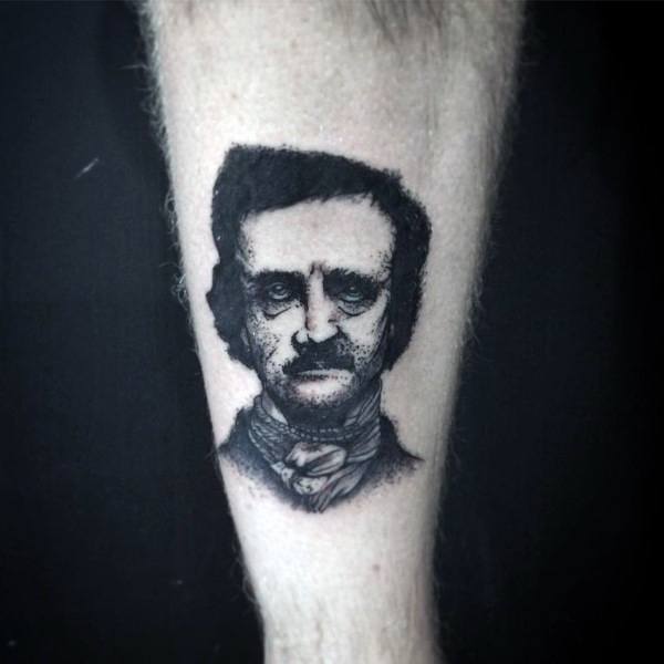 Small black and grey tattoo of Edgar Allan Poe with a somber expression, detailed shading, and subtle textured effects.