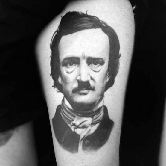 Realistic black and grey tattoo of Edgar Allan Poe with smooth shading, sharp details, and a calm, intense expression.