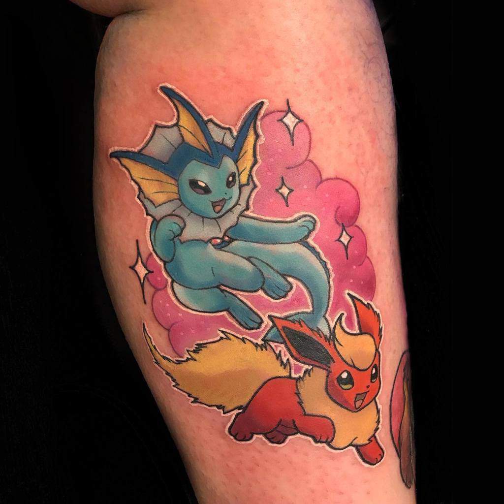 Tattoo of Vaporeon and Flareon with pink clouds and a hint of Eevee in the background