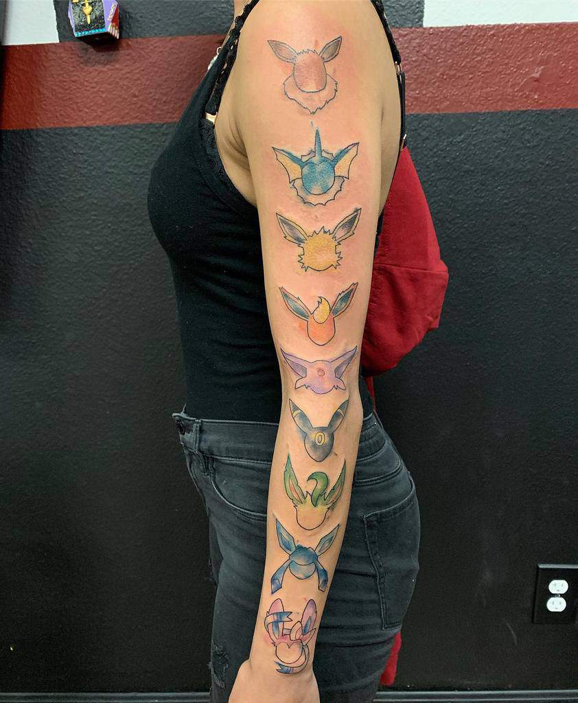Woman flaunting an Eevee evolution full tattoo sleeve