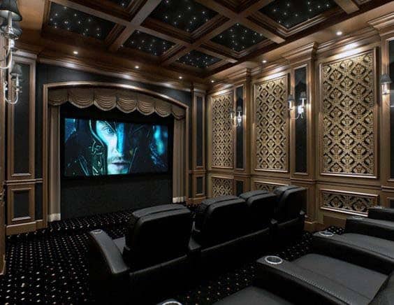 Luxury home theater with leather recliners, ornate paneling, and a starry ceiling displaying a movie