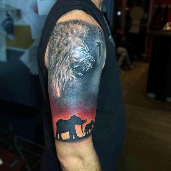 Elephants With Angry Lion Image On Sky Tattoo Guys Arms