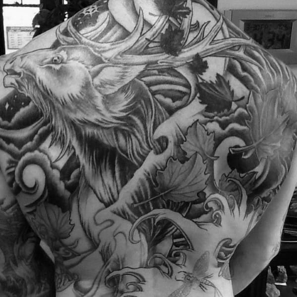 Large black and grey elk back tattoo featuring intricate shading, swirling clouds, and detailed foliage for a bold and dynamic design.