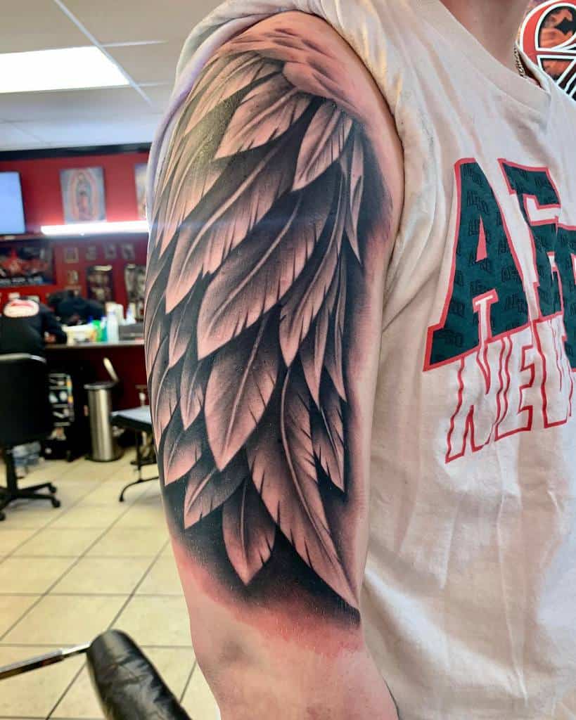 Detailed single angel wing tattoo, featuring layered feathers with smooth shading, creating a bold and dynamic design