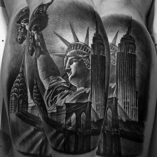 Empire State Building tattoo featuring Statue of Liberty, Brooklyn Bridge, and NYC landmarks in striking black-and-grey realism.