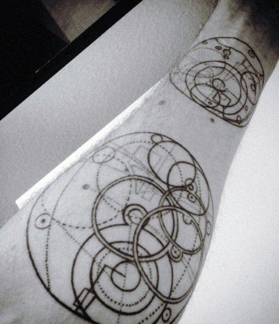 Tattoo of overlapping circular geometric patterns with fine lines and dots, resembling a cosmic or alien language on the forearm.