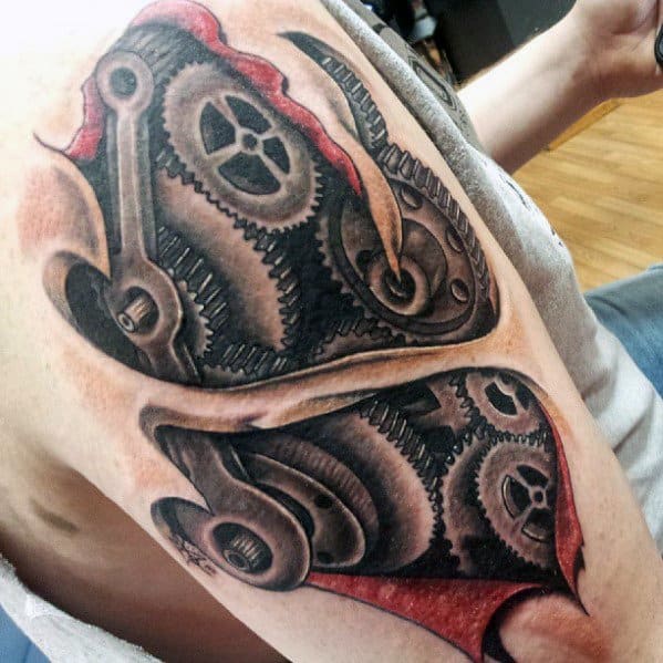 Tattoo of torn skin revealing intricate gears and mechanical parts beneath, creating a biomechanical illusion with vivid shading and red accents.
