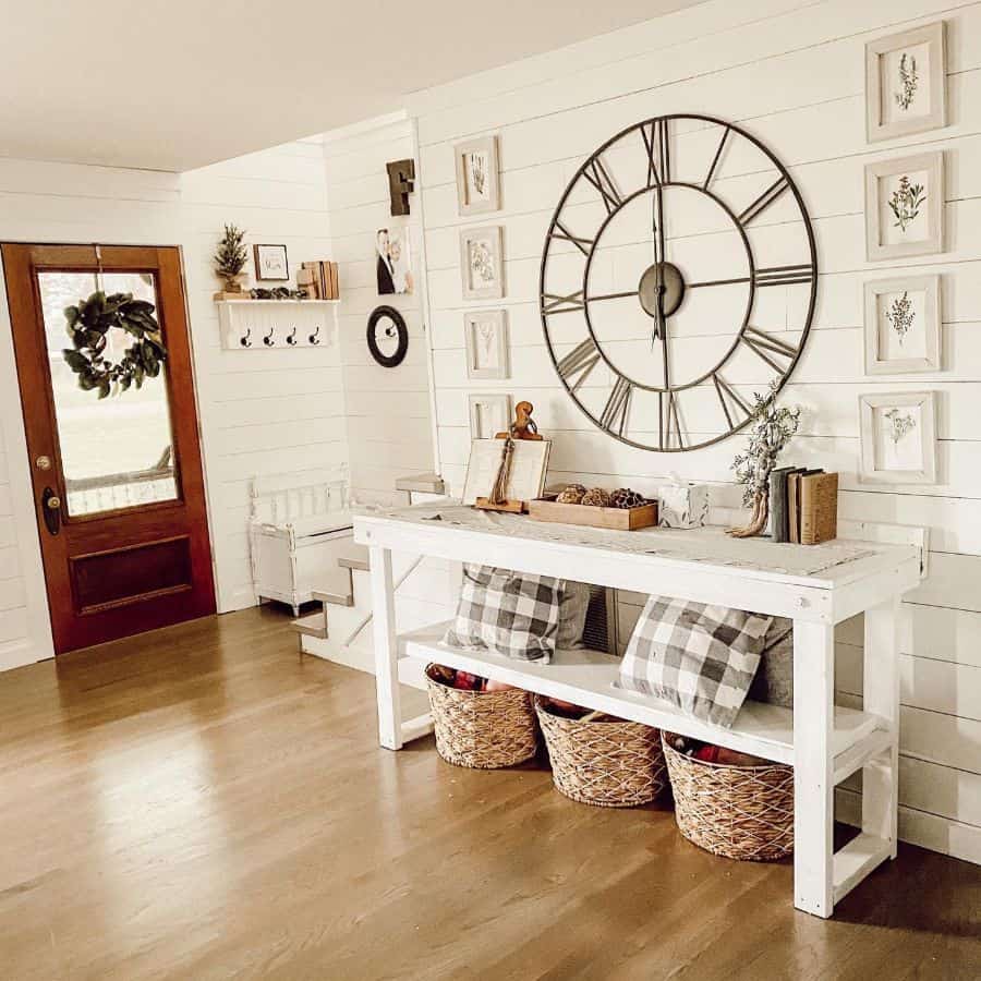 modern farmhouse entry way with large rustic wall clock and white table