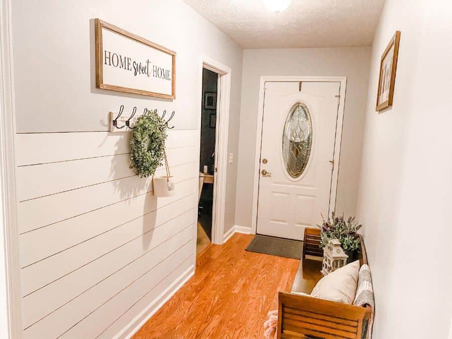 narrow white shiplap entryway with bench seat