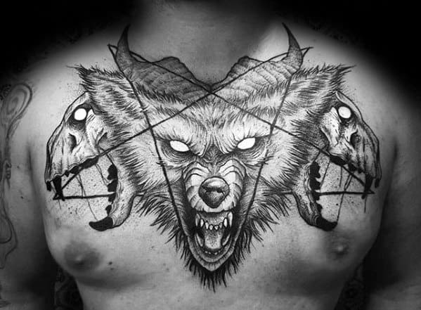 Tattoo of a fierce, glowing-eyed wolf head with horns, flanked by cracked skulls and intersecting geometric lines across the chest.