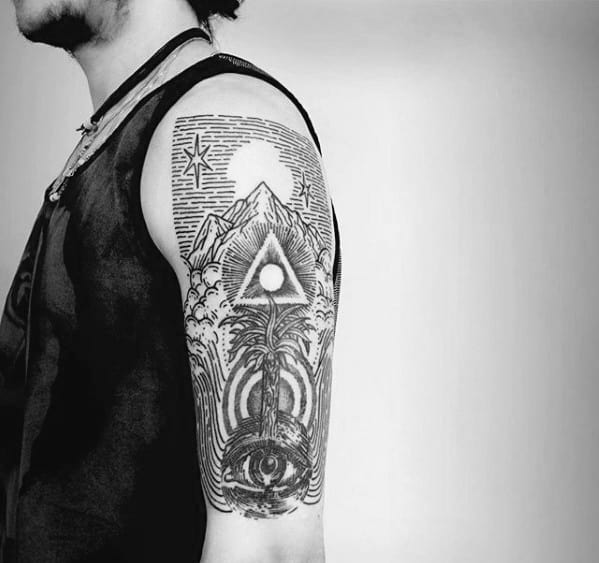 Tattoo of a mountain scene with a glowing triangle, cosmic elements, and an all-seeing eye surrounded by waves and mystical patterns.