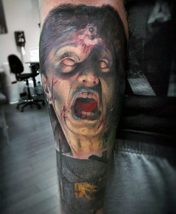 Terrifying Evil Dead tattoo of a possessed screaming face with white eyes, blood, and eerie shadows, capturing intense demonic horror.