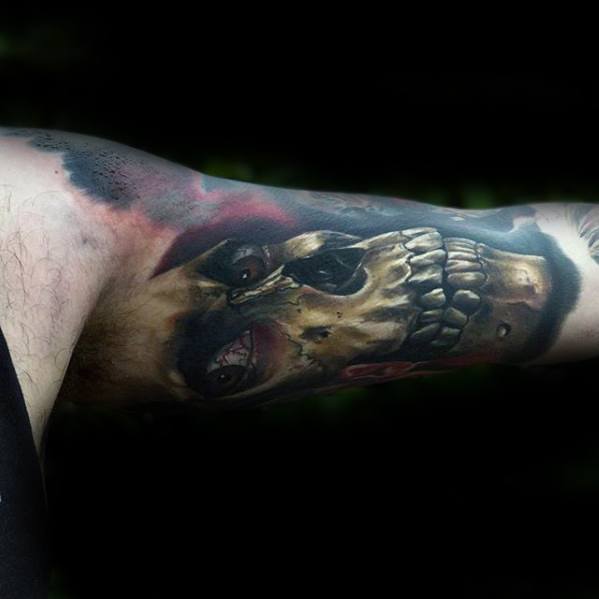 Dark and detailed Evil Dead tattoo of a sinister skull with bloodshot eyes and rotting teeth, surrounded by shadowy tones and eerie lighting.
