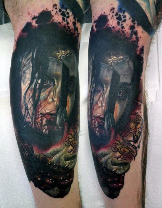Gruesome Evil Dead tattoo of a possessed woman's face with blood, dirt, and intense eyes, featuring a buried hand and dark, fiery background.