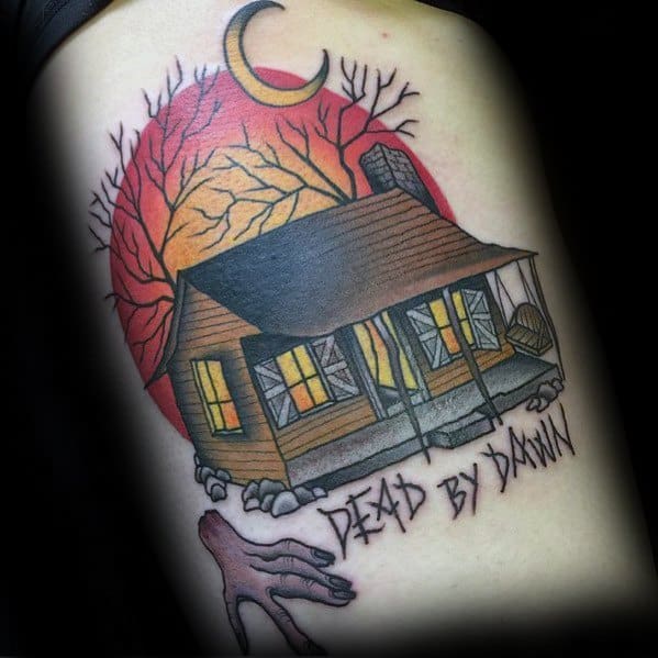 Evil Dead tattoo of the iconic cabin with glowing windows, a creepy hand, and “Dead by Dawn” text beneath a blood-red sky and crescent moon.