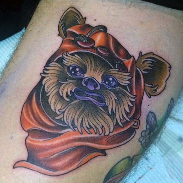 Vibrant Ewok tattoo with glossy purple eyes and lips, wearing a shiny orange hood with floral accents on the side.
